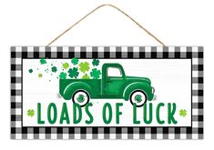 a sign that says loads of luck with a green truck and shamrocks on it