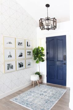 a living room with pictures on the wall and a blue door in front of it