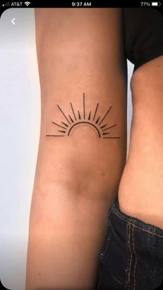 two women with tattoos on their arms and one has a sun tattoo on her arm