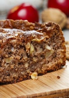 a close up of some bread on a table with apples and cinnamons in the background