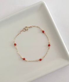 This dainty carnelian bracelet is handmade with genuine carnelian, and 14k gold filled and sterling silver metals. - Each bead measures 3mm. - Waterproof - Will not tarnish - Size up and wear as an anklet All of our jewelry is handmade with love in Nova Scotia, Canada. METALS Our jewelry is made using 925 sterling silver or 14k gold filled metals. Gold filled metals are made with a thick layer of gold to a brass core. Is is of higher quality than plated jewelry, and is a great alternative to pur Dainty Red Jewelry, Red Gold Bracelet, Carnelian Bracelet Jewelry Gift, Elegant Red Carnelian Beaded Bracelets, Red Carnelian Beaded Bracelets For Gift, Elegant Red Carnelian Bracelet, Red Carnelian Bracelets As A Gift, Red Carnelian Bracelets As Gift, Red Carnelian Bracelets For Gifts