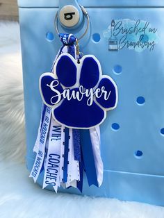 a blue bag with a keychain that says savvyer on it