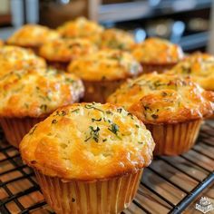 several muffins are cooling on a rack