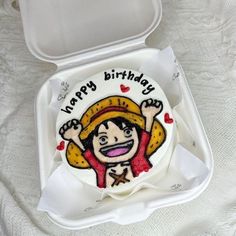 a birthday cake in a white box on a table