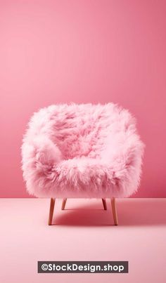 a pink chair sitting on top of a wooden frame in front of a pink wall