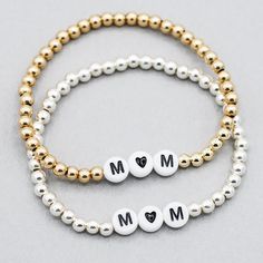 Add a little love to mom’s stack! Bracelet is made with 4mm sterling silver or 14k goldfill beads with “mom” in the center spelled with a heart. Easy wear and effortless bracelet stacking with stretch cord design Sizing options to make sure you have the perfect bracelet fit. Please contact us if you have any sizing questions or would like a custom size. Stacked Round Beads Jewelry As Gift, Stacked Round Beads Jewelry For Gift, Stacked Round Beads Jewelry Gift, Stackable Bracelets For Mother's Day, Everyday Stackable Bracelets For Mother's Day, Gold Beaded Bracelets For Mother's Day Gift, Dainty Letter Beads Jewelry For Anniversary, Mother's Day Name Bracelet With Letter Beads, Mother's Day Personalized Stackable Jewelry