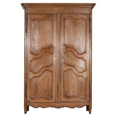 an old wooden armoire with carvings on the front and side doors, against a white background