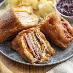 ham and cheese pastries on a plate with cranberry sauce