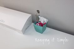 the toothbrushes are in their holder next to the electric toothbrush dispenser