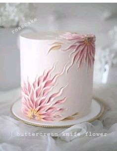 a white cake with pink flowers on it