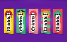 three colorful boxes with different types of candies on them, one has a mustache and the other has lips