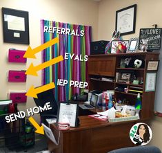 a desk with several items on it in front of a colorful curtain