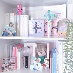 shelves with books, toys and pictures on them in a room filled with white walls