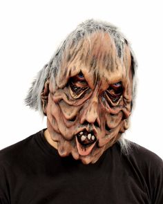 an old man with grey hair wearing a creepy mask