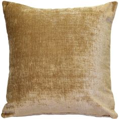 a gold velvet pillow on a white background