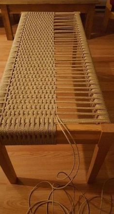 a table that has some kind of woven material on top of it and wires in front of it