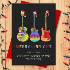 a christmas card with three guitars on it and the words merry and bright written below