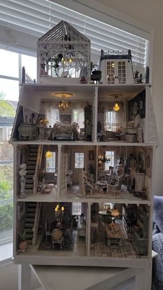 a doll house with lots of windows and furniture