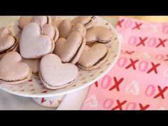 heart shaped cookies are on a plate next to pink and red napkins with hearts