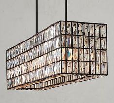 a chandelier hanging from a ceiling with pictures on the bottom and inside it