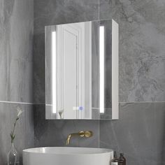 a white sink sitting under a bathroom mirror next to a wall mounted faucet