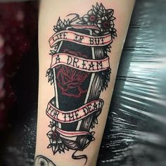 a tattoo on the arm of a woman with words and flowers around her ankles that reads, life is but a dream for the dead