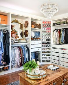 an organized closet with clothes, shoes and other items on shelves next to a coffee table