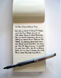 a notepad with writing on it next to a pen