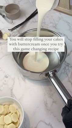 a person pouring milk into a pan with marshmallows on the counter top