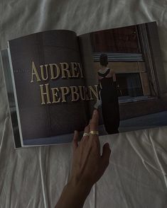 a person is holding an open book in their hand on a white sheet with the words auburn heppun