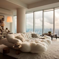 a living room filled with furniture next to tall windows and a large window overlooking the city