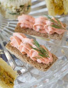 two slices of bread topped with salmon and dill