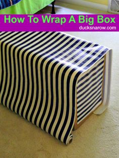 a striped box sitting on the floor with text overlay that reads how to wrap a big box