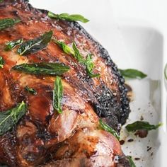 a close up of a plate of food with meat and greens on it's side