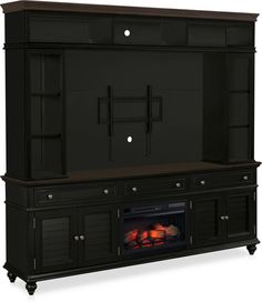 an entertainment center with a fire place in the middle and two doors on each side