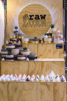 a display case filled with lots of different types of cakes and pastries on wooden shelves