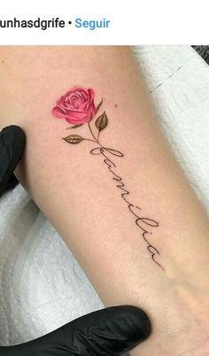 a woman's leg with a rose tattoo on it and the words love is written in cursive writing