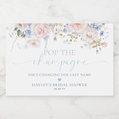 a white card with flowers and the words pop the champagne she's changing her last name