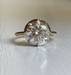 a diamond ring sitting on top of a table