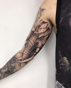 an elephant tattoo on the arm of a man