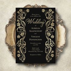 a black and gold wedding card with an ornate frame on the front, featuring roses