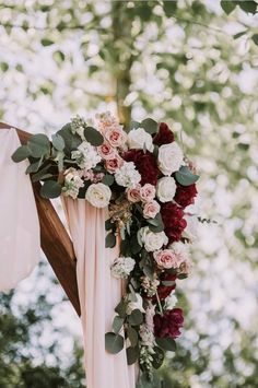 a wedding arch decorated with flowers and greenery