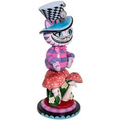 a figurine is sitting on top of a mushroom with a hat and dress