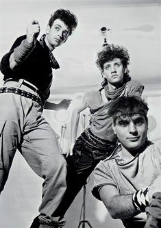 three young men are posing for a black and white photo