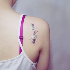 a woman with a tattoo on her shoulder