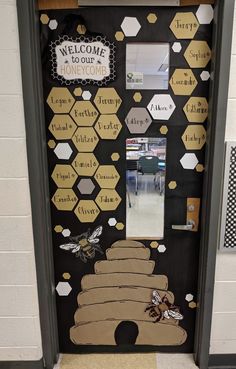 a door decorated with honeycombs and beehives for the welcome home sign