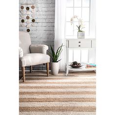 a white chair sitting in front of a window on top of a carpeted floor