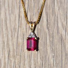 Ladies Yellow Gold Pendant set with Laboratory Grown Ruby and Diamonds. Crafted in yellow gold, this 3/4 inch pendant features an emerald cut laboratory grown ruby set with three accent diamonds. Purchase a yellow gold chain from our shop to make this the perfect everyday necklace. Each piece has been hand selected and meticulously identified and graded by a Graduate Gemologist who has been awarded a degree by the Gemological Institute of America (GIA). Please visit our Shop's About Page or our Gold Pendant Set, Ruby Set, Filigree Engagement Ring, Sterling Silver Bangle Bracelets, About Page, Everyday Necklace, Silver Bangle Bracelets, Yellow Gold Chain, Sterling Silver Bangles