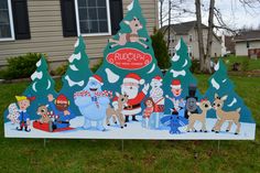 an outdoor christmas yard decoration with santa and reindeer