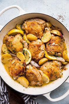 chicken with lemons and onions in a skillet